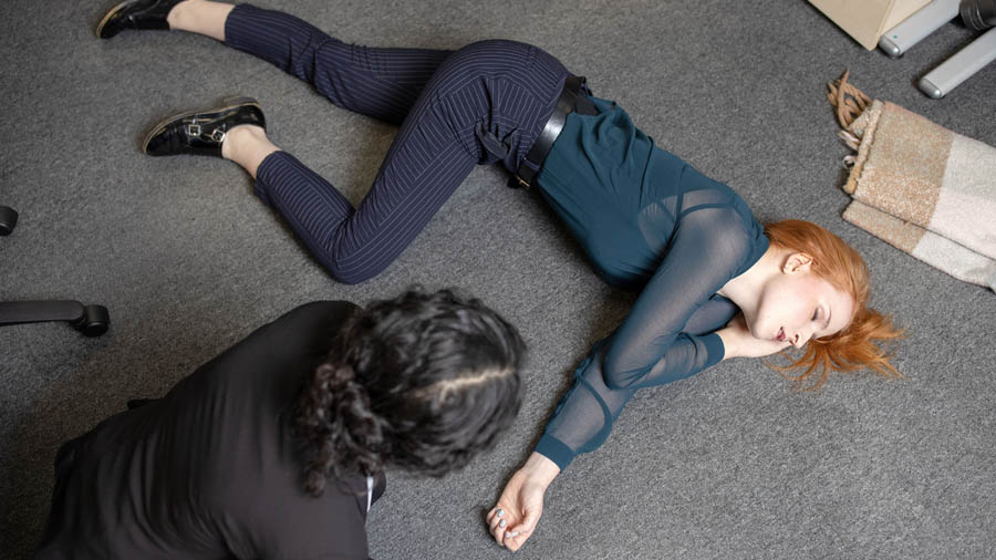 Performing first aid for a teacher at a school