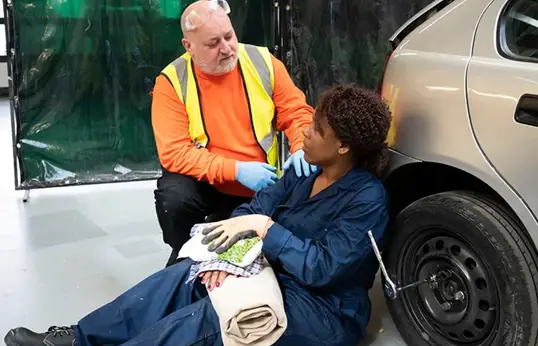 First Aider Helping A Casualty In The Workplace Blog Page