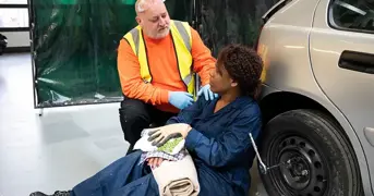 First Aider Helping A Casualty In The Workplace Listing Page