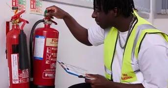 Fire Marshal Checking A Fire Extinguisher Listing Page