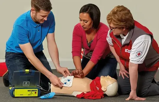 First Aider Learning How To Use Aed Pads On A Course Blog Page